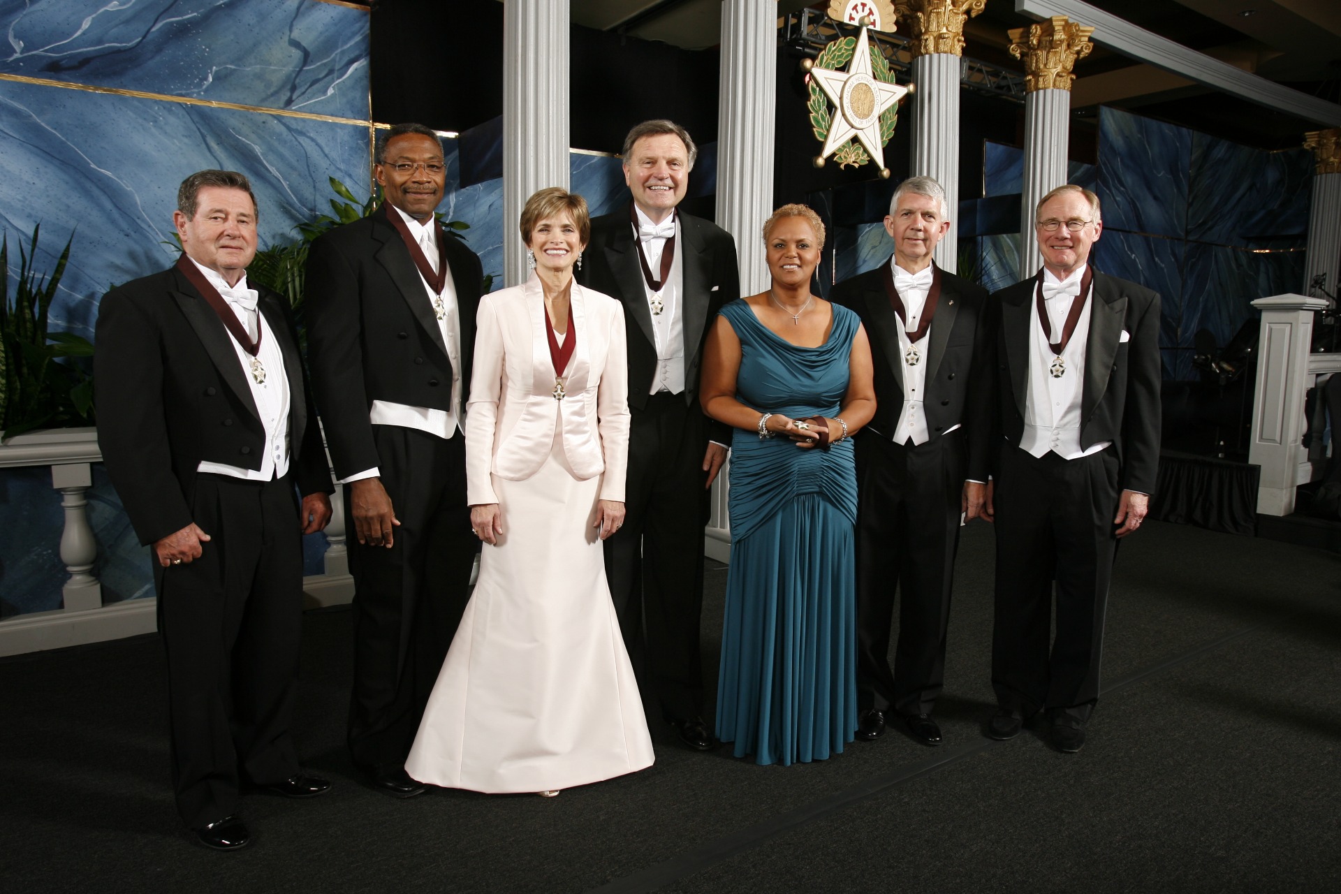 Regina Tisdale (3rd from right) accepted Wayman Tisdale's medallion at the induction ceremony following his passing. She is pictured with the Oklahoma Hall of Fame Class of 2009 at that November event. Courtesy Oklahoma Hall of Fame Archives.